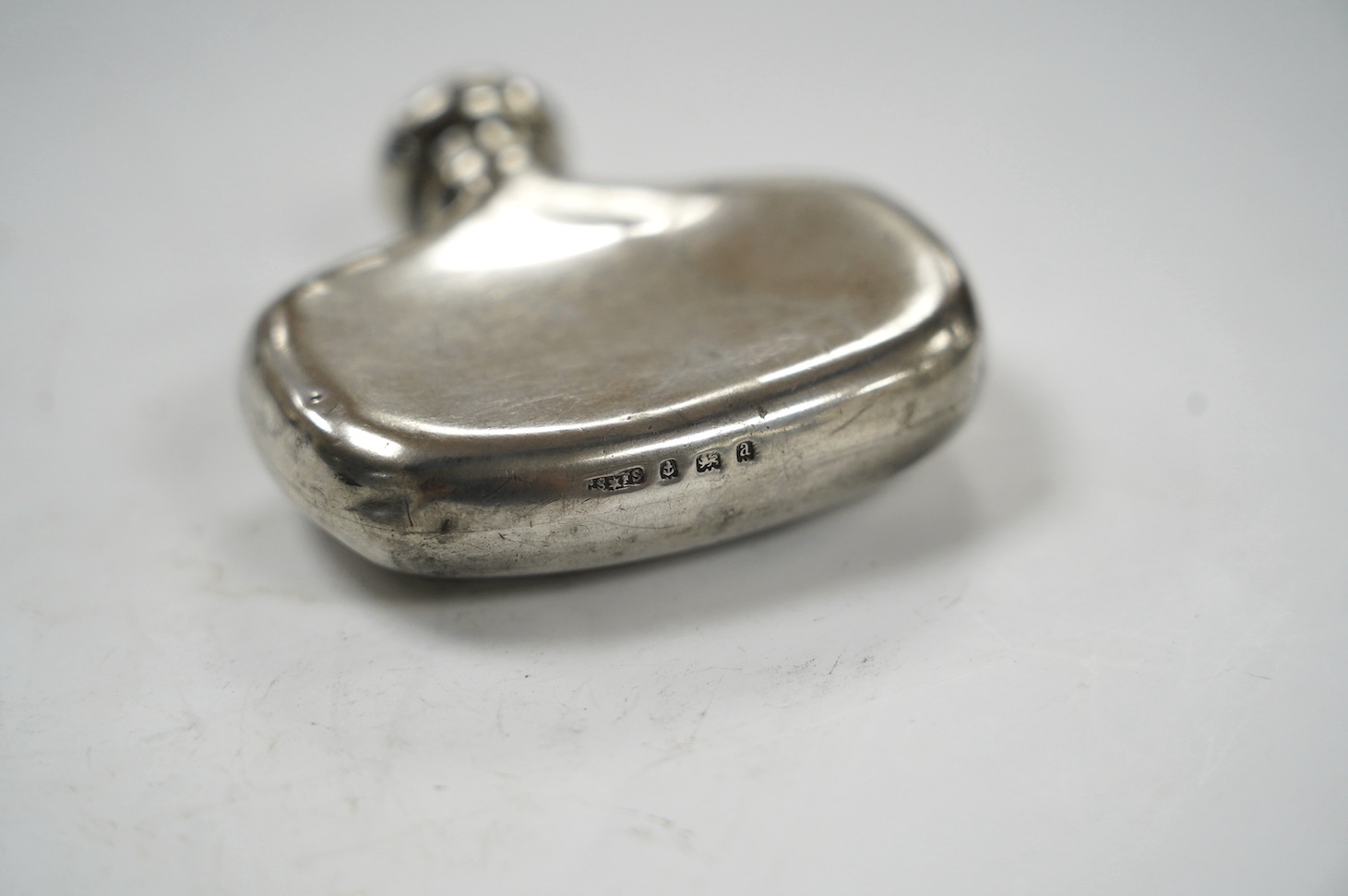 A late Victorian small silver hip flask, by Saunders & Shepherd, Birmingham, 1900, width 62mm. Condition - poor to fair
